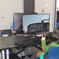 Students use a flight simulator at West Michigan Aviation Academy